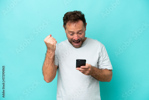 Middle age caucasian man isolated on blue background surprised and sending a message