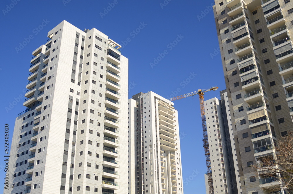 Beautiful white residential buildings. Modern area, new buildings. Real estate in Israel. Tenement house Tall new residential buildings against the sky, space for text