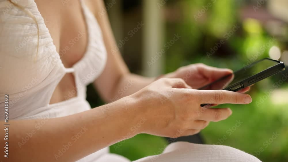 Unrecognizable woman using smart phone texting with AI, surfing social media, checking news, playing mobile games or texting messages sitting otside. Female spending time with cell gadget close-up Unrecognizable woman using smart phone texting with AI, surfing social media, checking news, playing mobile games or texting messages sitting otside. Female spending time with cell gadget close-up