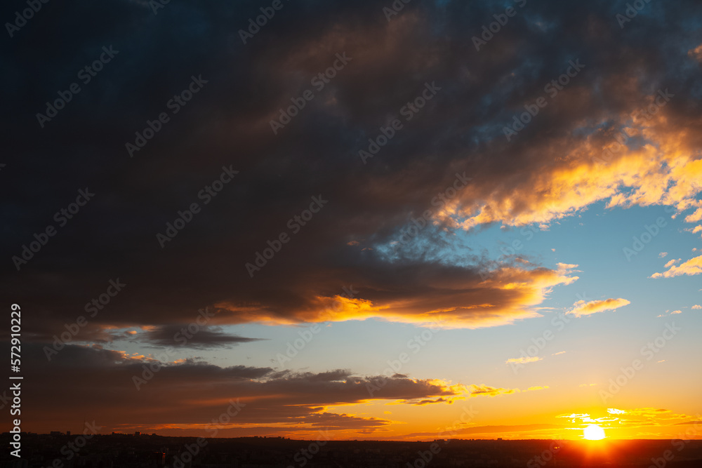Natural landscape of colourful sunset or sunrise with dark clouds.