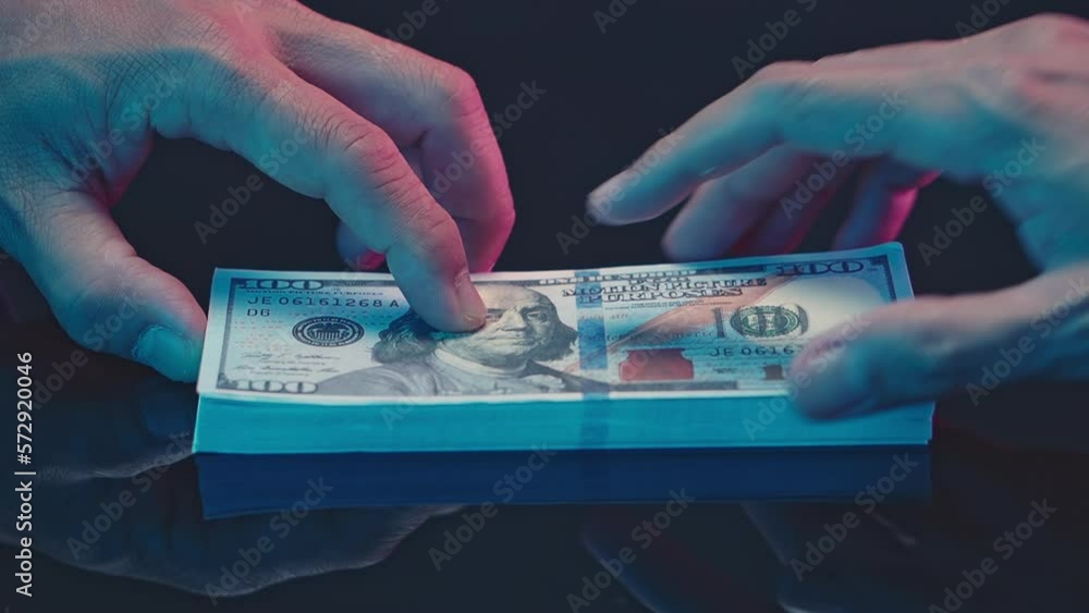 Close up hands giving money - United States Dollars (or USD) bribe payment. offering batch of hundred dollar bills bribery financial economy business people. Venality, bribe, corruption concept. Close up hands giving money - United States Dollars (or USD) bribe payment. offering batch of hundred dollar bills bribery financial economy business people. Venality, bribe, corruption concept.