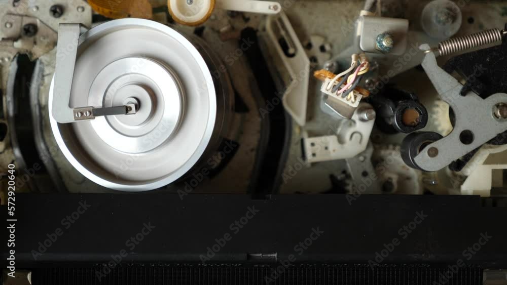 Loading a VHS tape and the operation of the tape extension mechanism of the video player. View from above. Video imaging technologies. Loading a VHS tape and the operation of the tape extension mechanism of the video player. View from above. Video imaging technologies.