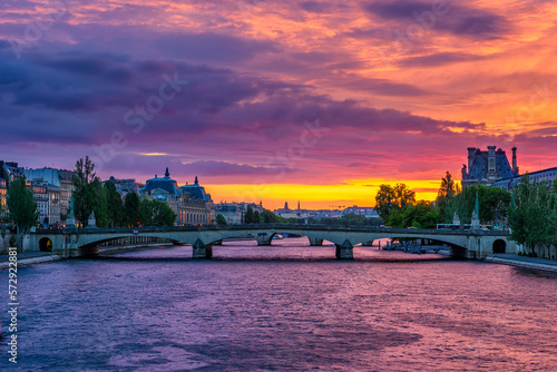 Sunset view of Seine river, Pont du Carrousel in Paris, France. Cityscape of Paris. Architecture and landmarks of Paris