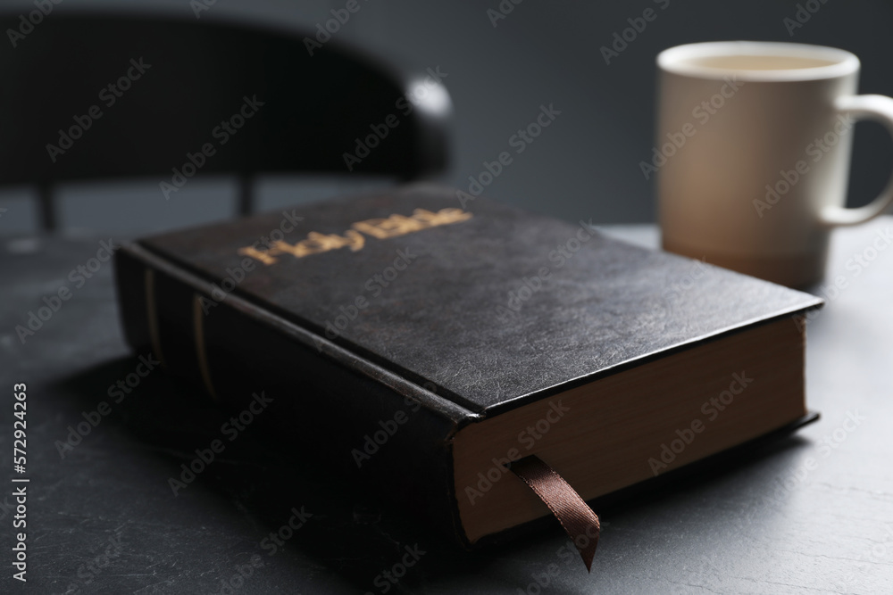 Hardcover Bible on black table indoors, closeup. Religious book Hardcover Bible on black table indoors, closeup. Religious book