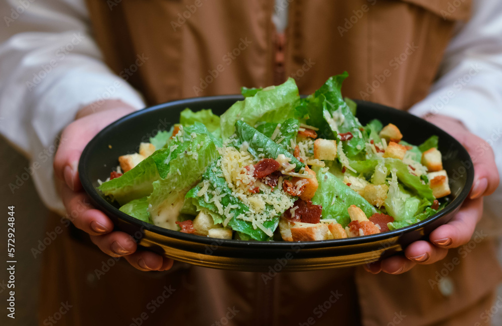 Caesar salad served with organic lettuce, crispy bread and sprinkled with cheese is a meal for health lovers. Caesar salad served with organic lettuce, crispy bread and sprinkled with cheese is a meal for health lovers.