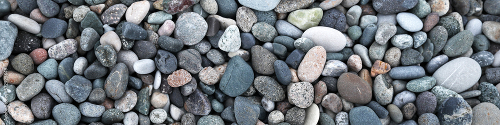 Many different pebbles as background, top view. Banner design Many different pebbles as background, top view. Banner design