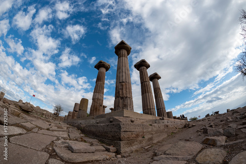 View of Assos Athena Temple ruins of Canakkale province with clouds on blue sky photo