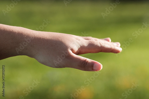 Close-up of isolated woman hand with grass background. © Jorge Elizaquibel