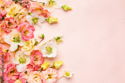 Spring Flowers composition with Eustoma and Helleborus on pastel pink background. Floral concept for Easter, Woman's day or Valentine's day.