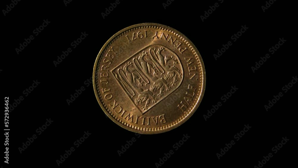 Rotating reverse of Jersey coin half new penny 1971, isolated in black background. 4k video. Rotating reverse of Jersey coin half new penny 1971, isolated in black background. 4k video.