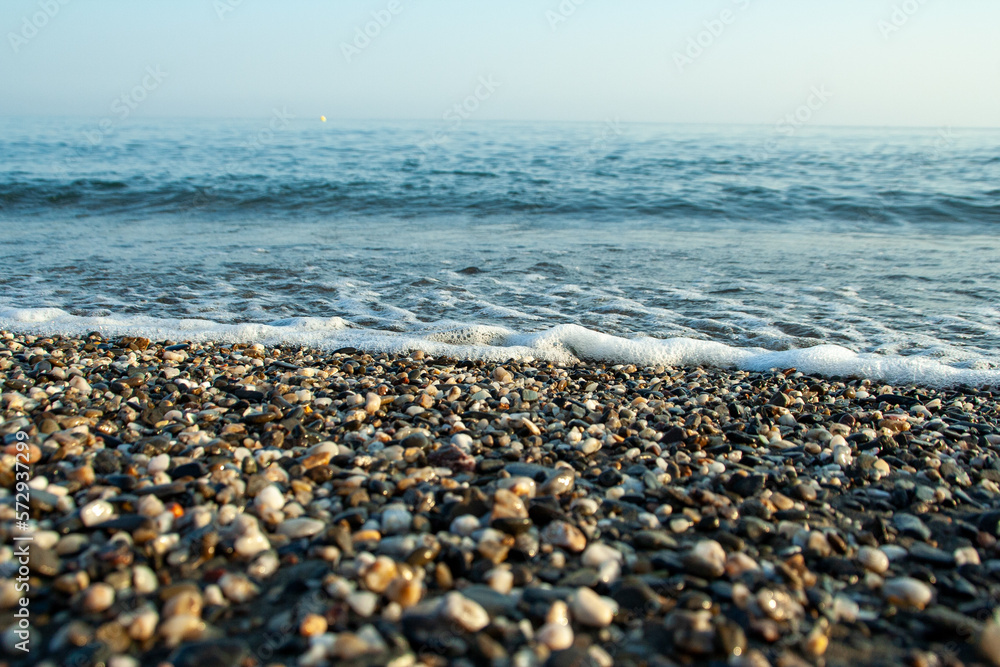 The mediterranean sea washing over a stony beach The mediterranean sea washing over a stony beach