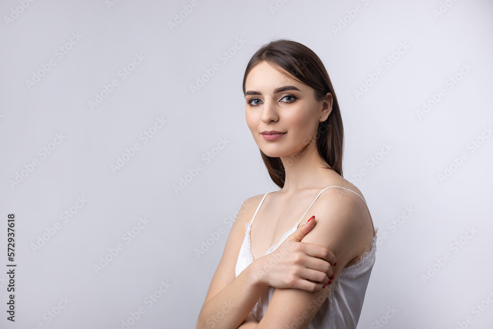 Beautiful smiling woman with clean skin, natural make-up and white teeth on a gray background Beautiful smiling woman with clean skin, natural make-up and white teeth on a gray background