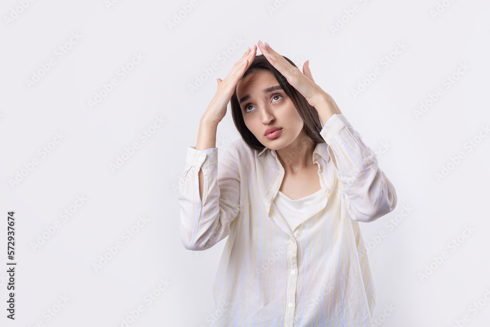 Portrait of a serious young woman showing stop gesture with her palm over white background Portrait of a serious young woman showing stop gesture with her palm over white background