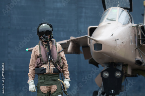 Slika na platnu Fighter pilot standing with fighter Jet ready for a combat mission wearing flyin