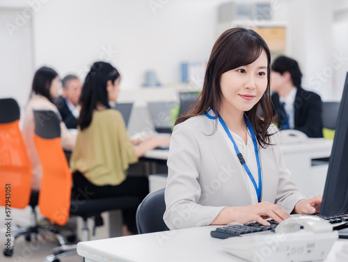 Plakat 笑顔でデスクワークをする女性