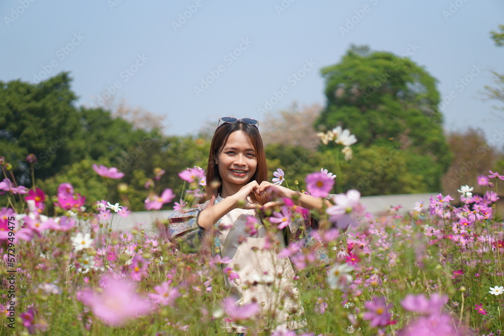 Happy Asian woman in cosmos flower garden Happy Asian woman in cosmos flower garden