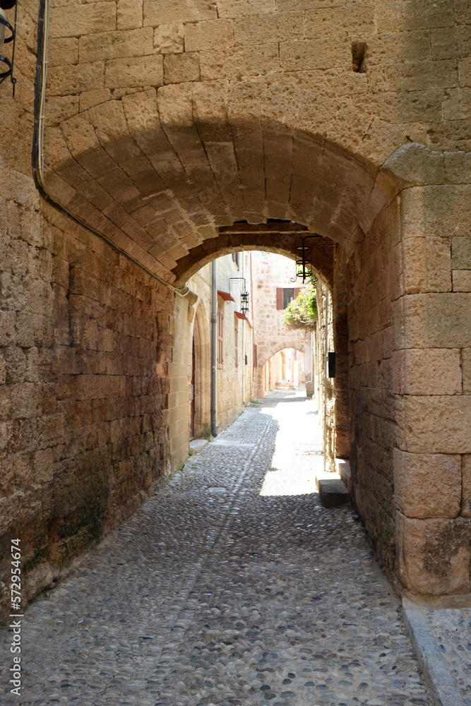 ancient medieval street with arched tunnel and brick walls isolated, close-up