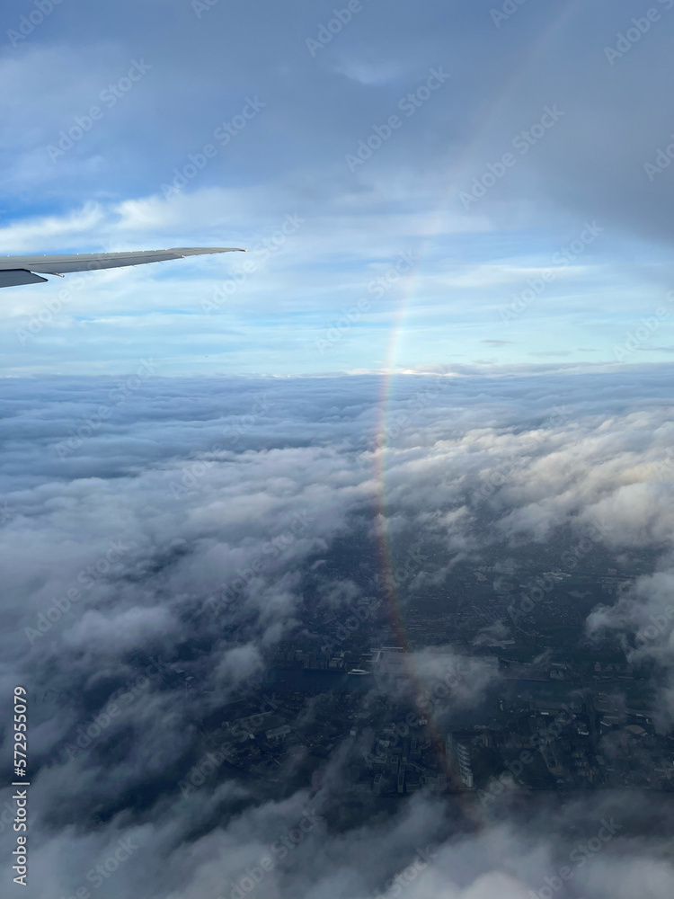 view from airplane window of a rainbow view from airplane window of a rainbow