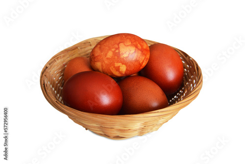 Easter basket with naturally dyed Easter eggs isolated on white background