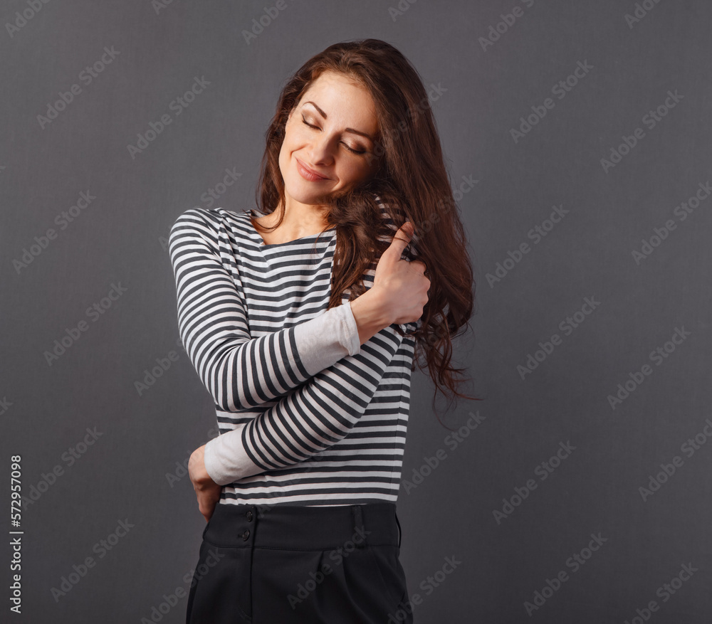 Happy makeup business woman hugging herself with natural emotional natural makeup face in blue stripped shirt. Closeup portrait Happy makeup business woman hugging herself with natural emotional natural makeup face in blue stripped shirt. Closeup portrait