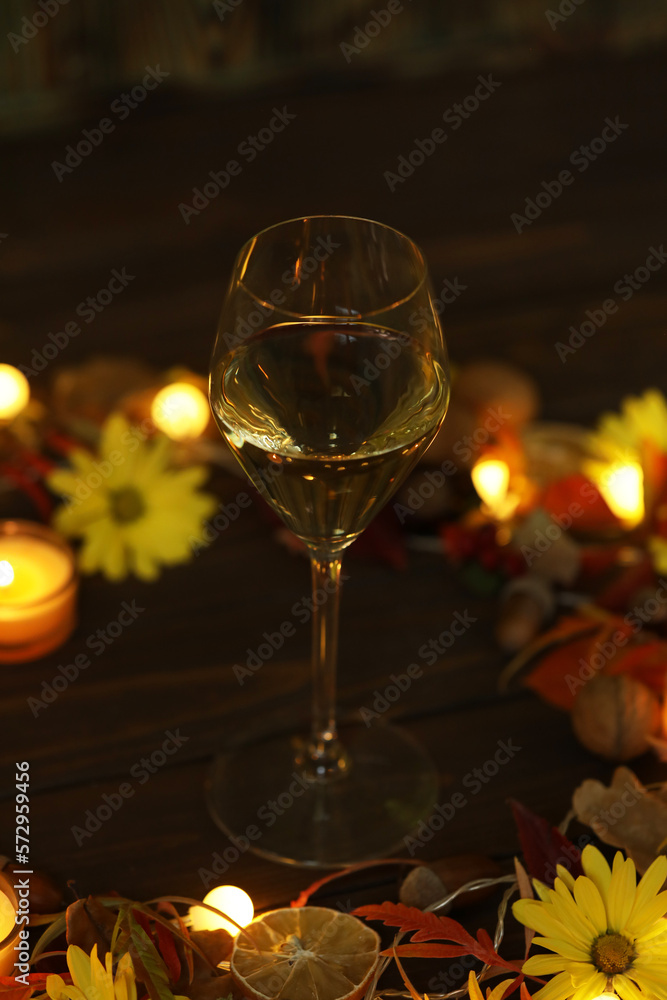 glass of white wine with autumn decoration