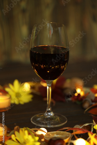 glass of red wine with autumn decoration