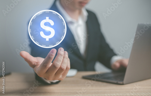 Man hand holding dollar sign.