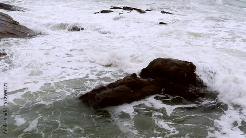 Sea waves crashing on the rocks in Brazilian beach photo