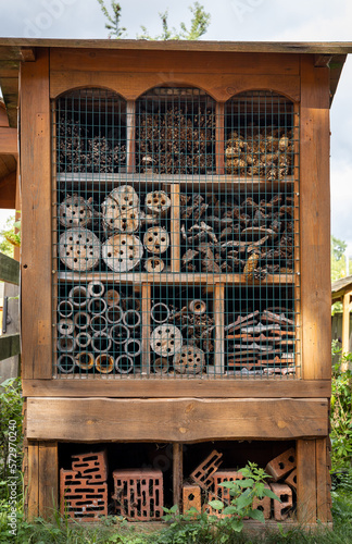 Close-up of a wooden insect hotel, a shelter for different kinds of bugs and bees.  photo