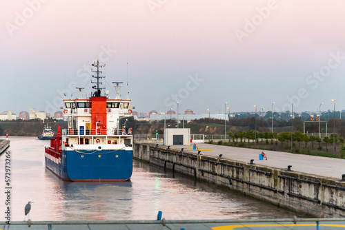 Merchant ship entering the river port of Seville from the lock, on the Guadalquivir River.