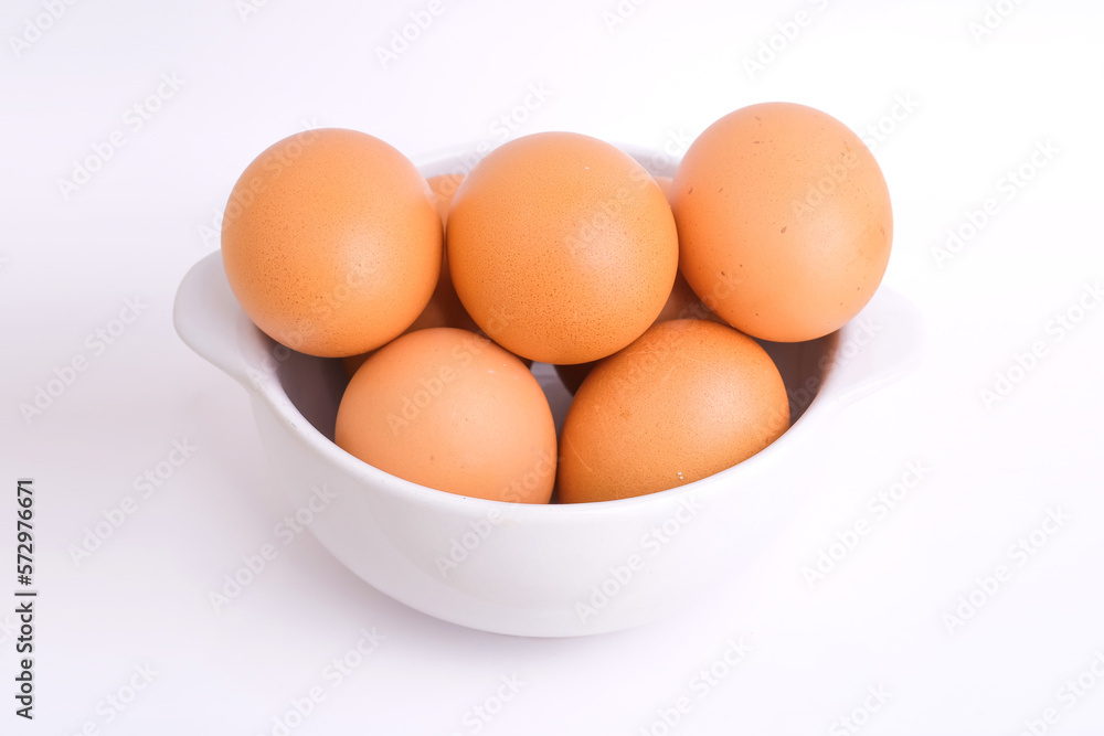 Fresh chicken eggs in a white bowl on a white background Fresh chicken eggs in a white bowl on a white background