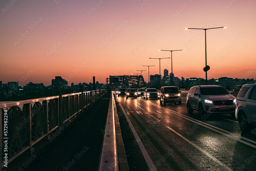 sunset over the bridge with traffic 