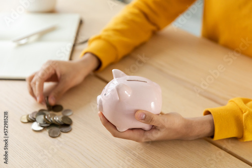 Saving money investment for future. Female woman hands holding pink piggy bank and putting money coin. Saving investment budget business wealth retirement financial money banking concept