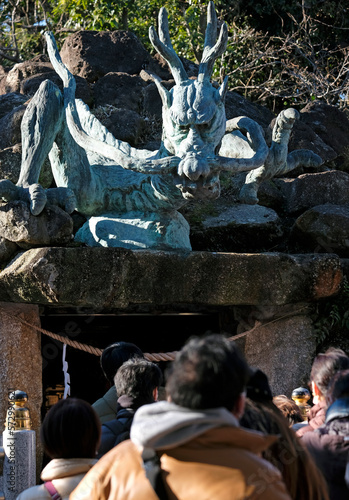 Wallpaper Mural Dragon statue at Dragon Palace, part of Enoshima Shrine on Enoshima peninsula with anonymous people seen from the back on a sunny day Torontodigital.ca