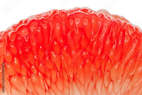 Grapefruit slice peeled segmented in background light, close-up, red citrus fruit isolated on white background with clipping path