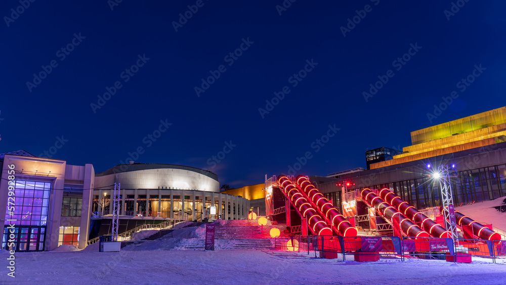the Montreal en lumière festival attracts tourists to the Cartier Des Spectacles who can skate on the high skating rink and slide down the steps of Place Des Arts