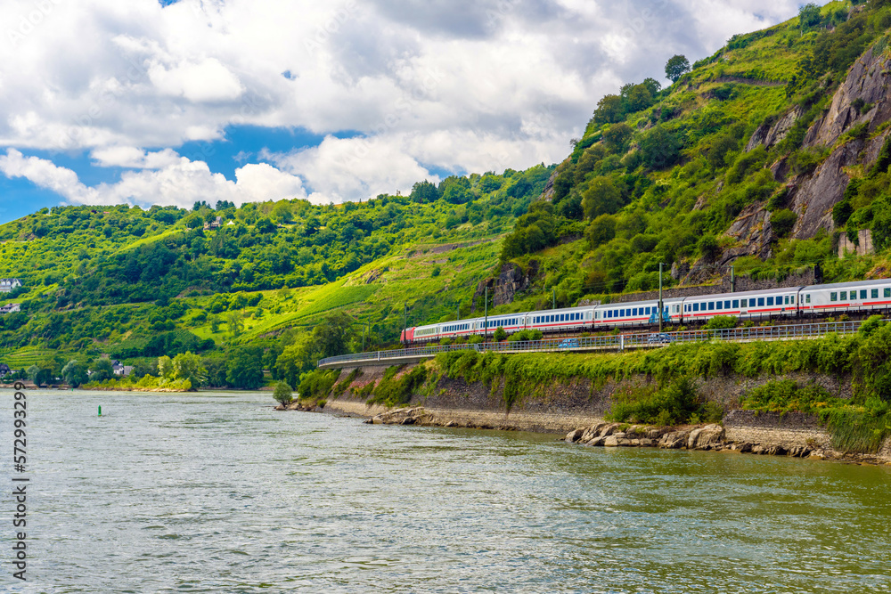 Fototapeta premium Intercity express train IC in Rhein Rhine river in Loreley, Rhein-Lahn-Kreis, Rhineland-Palatinate, Rheinland-Pfalz, Germany