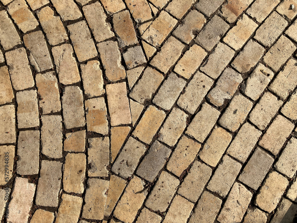 Yellow brick road. Yellow stone tiles masonry closeup background. the texture of yellow antique paving stones. Old yellow pavement in a pattern. Yellow brick road. Yellow stone tiles masonry closeup background. the texture of yellow antique paving stones. Old yellow pavement in a pattern.