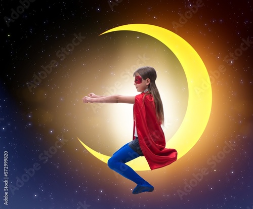 Superhero kid sitting on the moon crescent