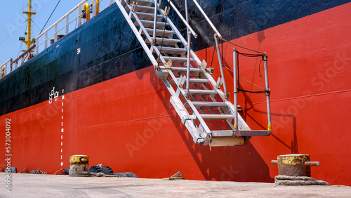 Photography Perspective side view of white gangway accommodation ladder of red and black oil
