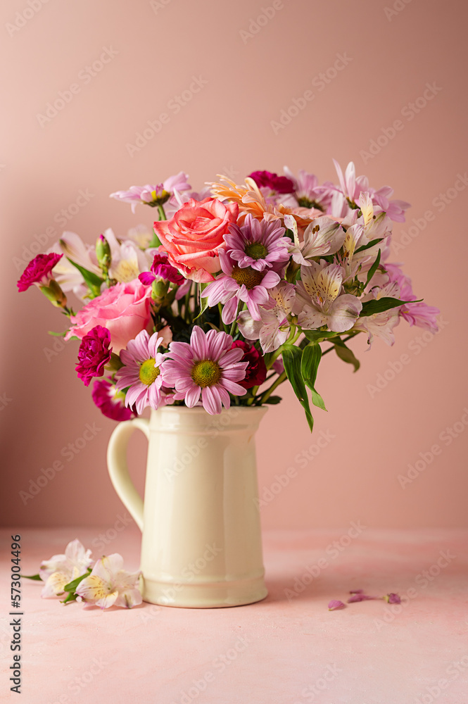 Beautiful fresh flowers. Pink bouquet of flowers in vase, on pink background. Beautiful fresh flowers. Pink bouquet of flowers in vase, on pink background.