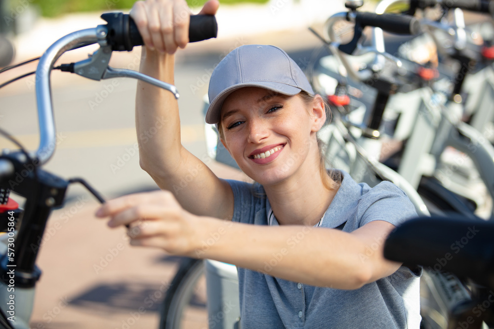 Fototapeta premium female bicycle mechanic repairing bikes outdoors