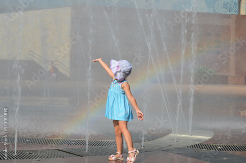 A child plays with the fountain jets