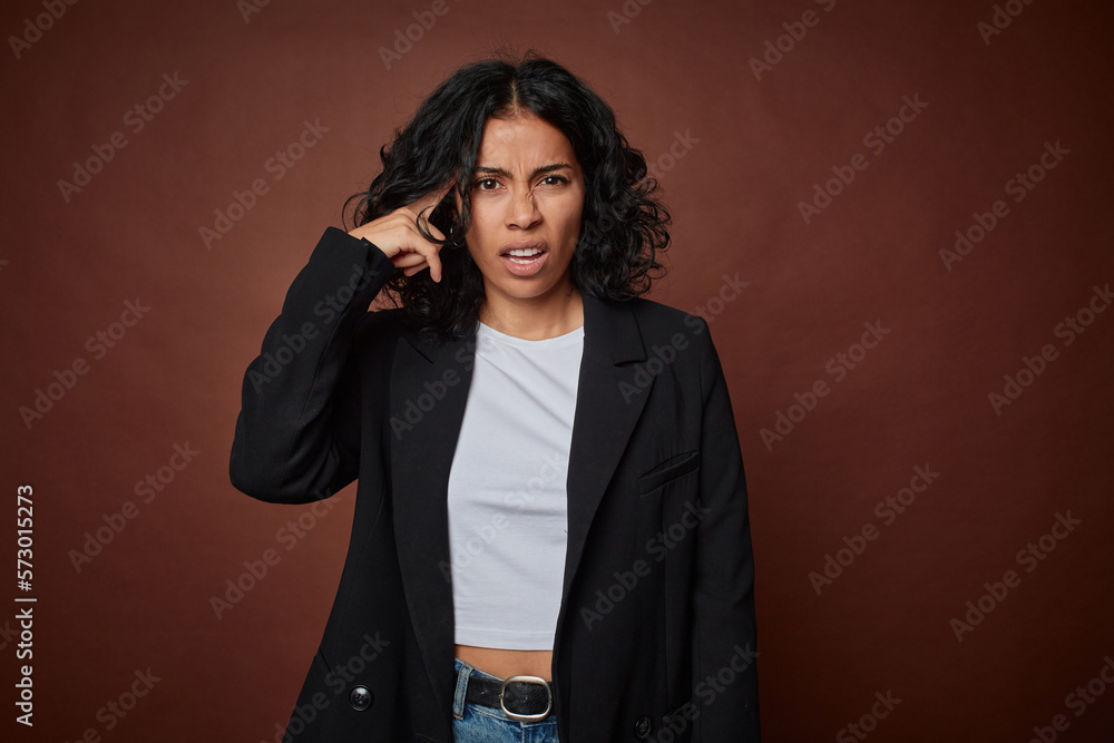 A young business colombian woman showing a disappointment gesture with forefinger.