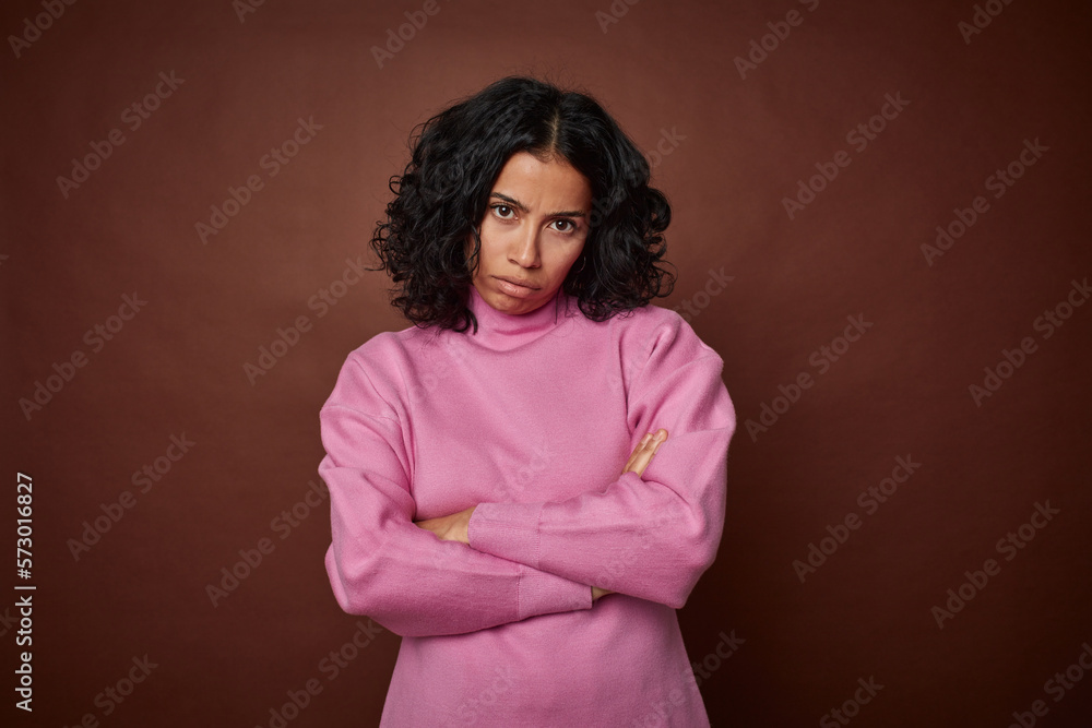 Young colombian curly hair woman isolated on brown background who is bored, fatigued and need a relax day. Young colombian curly hair woman isolated on brown background who is bored, fatigued and need a relax day.