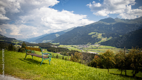 bench with a view of green valley in nice weather