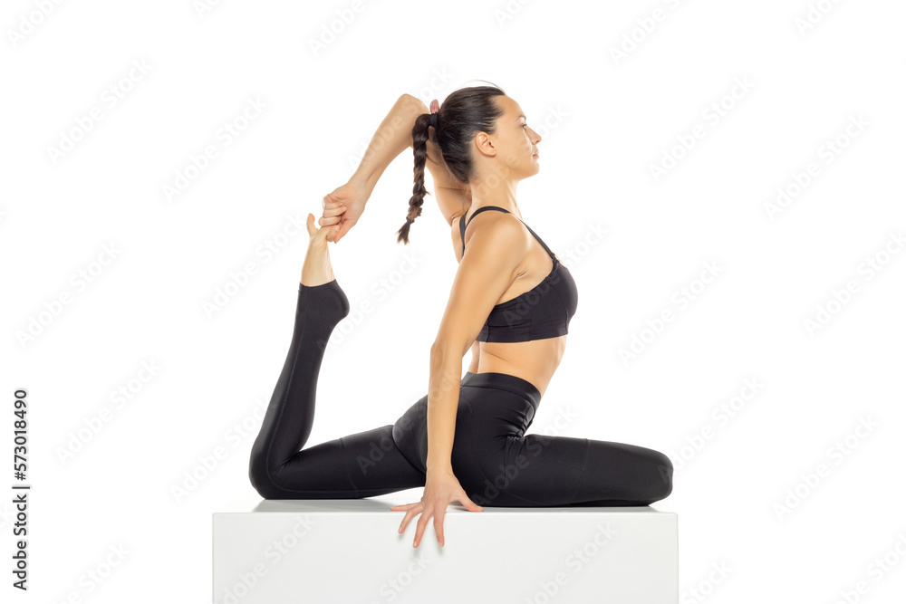 Portrait of young beautiful woman in black sportswear doing yoga practice. Portrait of young beautiful woman in black sportswear doing yoga practice.