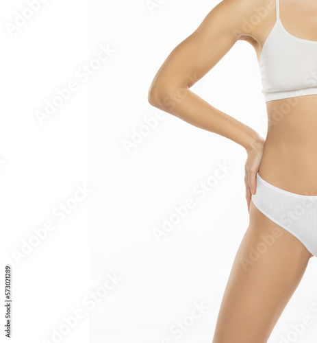 Slim woman in top form, perfect body shape. Parts of woman body in underwear, white background shoot.