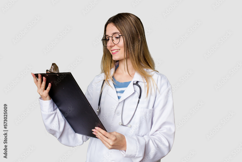 Young doctor woman in uniform reading files isolated Young doctor woman in uniform reading files isolated