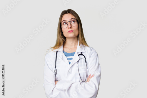 Young female doctor confidently gazing at the camera.